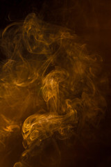 Gold smoke on black background.