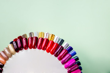 Nail polish samples in different bright colors. Colorful nail lacquer manicure swatches. Top view of nail art samples palette. Free copy space. Nail salon. Beauty concept