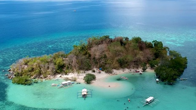 Aerial shot of boats docked at CYC beach CYC Island, Coron town, Philippines