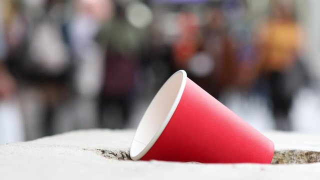 Close up on cup in busy city