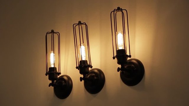 Three yellow 3200k industrial LED wall lamps in a white wall - Industrial design - Black color dark scene