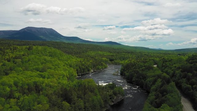 Flying above white water on the Penobscot River with Mount Katahdin in the distance AERIAL
