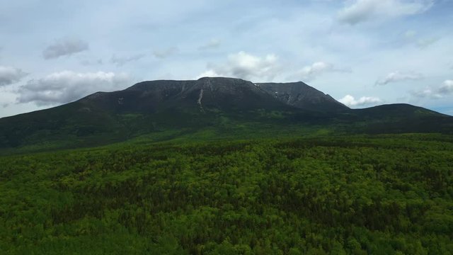 Slowly flying over Baxter State Park towards Mount Katahdin Late Spring AERIAL