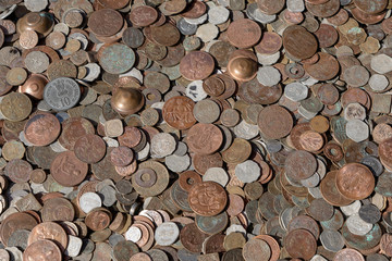 Old vintage fake coins background for sale to tourists in the Indian market on the street in Rishikesh, India. Close up