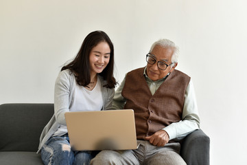 Asian family relationship, Daughter and elderly father using laptop computer together, Senior...