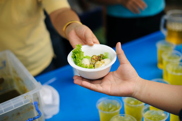 Participation in sharing food for the poor : The Concept of Love : The beggar is waiting for food from charity aid : Charity food shared to everyone in society and the poor need this charity food