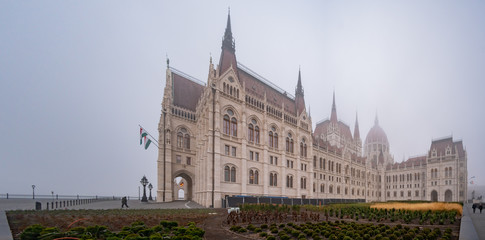 Fototapeta premium Foggy view of the Hungarian Parliament Building in a haze morning