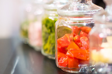Fototapeta na wymiar Tomatoes in glass jar, preservation of tomatoes, Selective focus