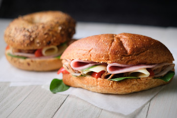 Delicious classic blt sandwiches with ham, cheese, bacon, tomatoes. Breakfast and fast food meal. on isolated black background wooden and text copy space.