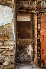 Old brown wooden door in opsharpanny building. Vertical.