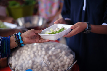 Poor people receiving food from donations : Homeless people are helped with food relief, famine...