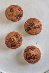 home made chocolate chip muffins in a muffin tray