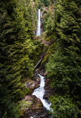 Beautiful tall waterfall deep in lush green forest