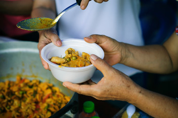 The concept of humanitarianism : The hands of refugees have been aided by charity food to alleviate...
