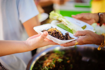 The concept of the beggar problem on earth : The Hand of the Beggars receives charity food from fellow human beings : The hands of refugees have been aided by charity food to alleviate hunger