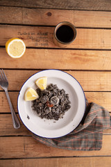 Plate of black rice with squid and prawns or Valencian black paella