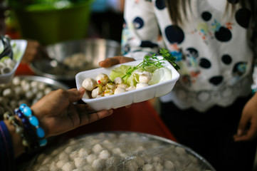 Homeless people pick up charity food from the food donors in society : The concept of the beggar problem on earth : The Hand of the Beggars receives charity food from fellow human beings