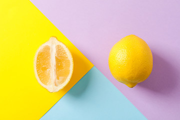 Fresh lemons on color background, space for text