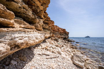 Wild and picturesque sea shore with stones on Crimean coast of Black sea in the area of Chersonesos cape.