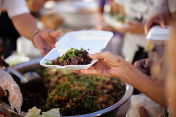 Concept homelessness : Food needs of the poor in society Help with Food Donation : Homeless people pick up charity food from the food donors in society : The concept of the beggar problem on earth