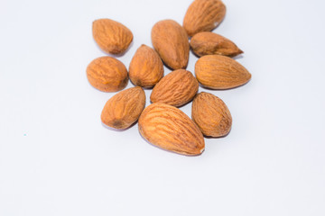 close up of  brown almonds seeds isolated on white background
