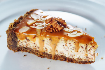 Tasty Cheesecake with Caramel and Walnut Closeup. Sweet Dessert Consisting of One Layer Made of...