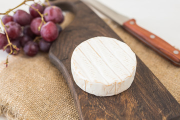 Cheese brie with on rustic wooden board