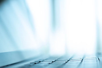 Close up Laptop keyboard. Selective and soft focus. Subject is blurred. blue theme