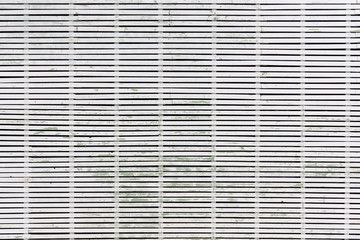 Large wall faced with green wooden planks, painted with white paint