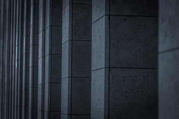 Vertical elements of the facade of a modern building. Dark toned image