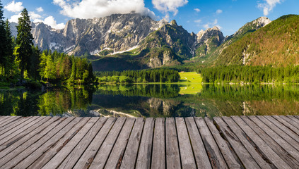Mountain lake with wooden floor background
