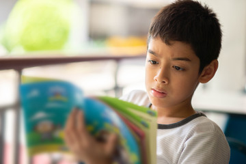 Little boy reading a book