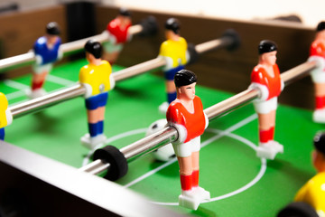 A close up side view of a foosball table