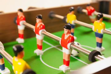 A close up side view of a foosball table