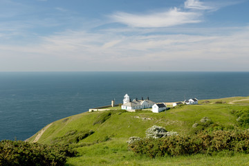 Fototapeta na wymiar Lighthouse beside the coastal path near Durlston Castle on the Dorset coast