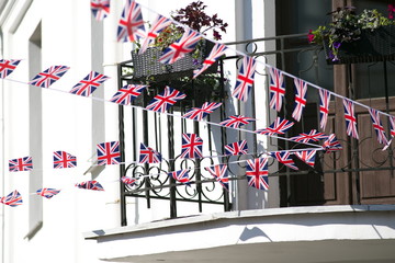 pretty many United Kingdom (UK) flags placed diagonal with bokeh and free space for your content - any celebration flag 3d illustration