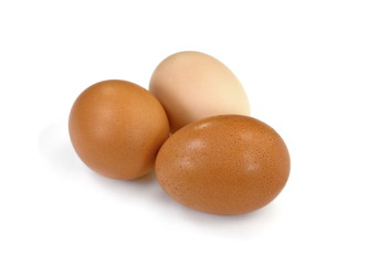 Raw Eggs on White Background.  Brown and white eggs.