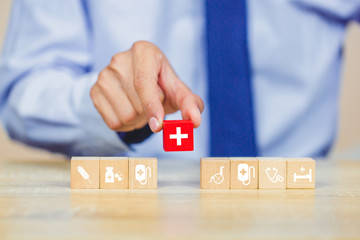 Health Insurance Concept,hand arranging wood block stacking with icon healthcare medical.