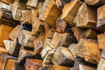 Thick pine firewood in stack on top of each other.