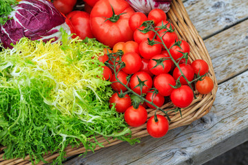 fresh tomatoes and lettuce in a basket
