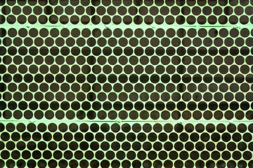 Green grating in the hole. Background.