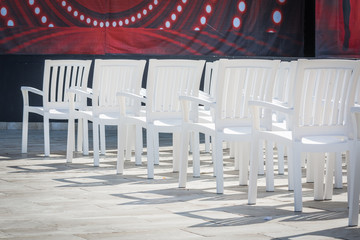white chairs for watching performances on stage.