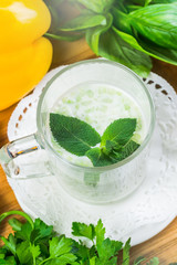 homemade zucchini creamy soup  in mug on a light background