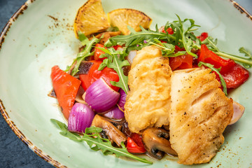 Pieces of fried fish with vegetables. Top view