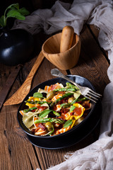 Pasta salad with green asparagus, olives and parma ham