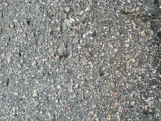 old asphalt pavement with prominent stones