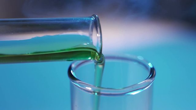 Pouring reagent into test tube