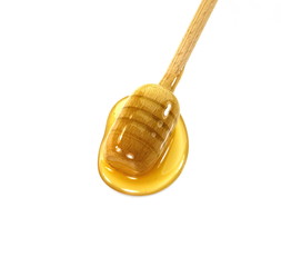Honey and dipper isolated on white background.