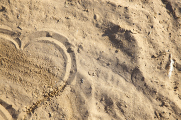 Fototapeta na wymiar Heart on the sand. Summer concept