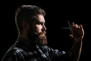 Mans haircut in barber shop. Profile of stylish beard man, scissors. Barber scissors, barber shop. Brutal male, hipster with moustache. Male in barbershop, haircut, shaving